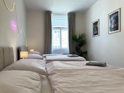 a group of four beds in a room at 100m2 Wenceslas Comfort, 3BDR with Netflix in Prague