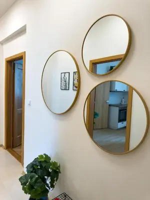 two circular mirrors on a wall in a living room at 100m2 Wenceslas Comfort, 3BDR with Netflix in Prague