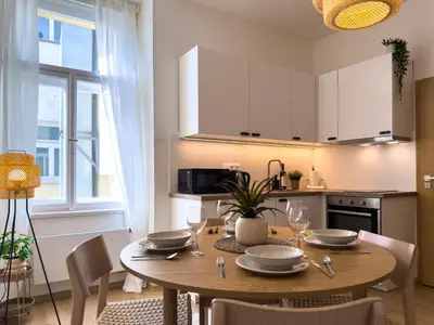 a kitchen with a wooden table and a dining room at 100m2 Wenceslas Comfort, 3BDR with Netflix in Prague
