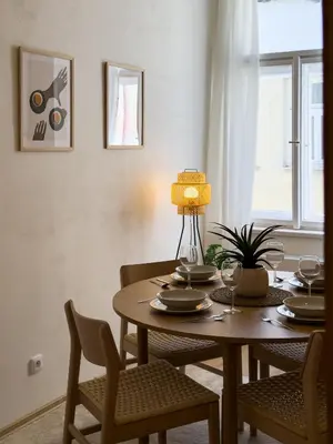 a dining room with a table and chairs and a window at 100m2 Wenceslas Comfort, 3BDR with Netflix in Prague