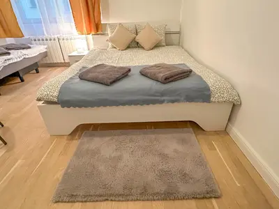 a bed with two pillows on it in a bedroom at Cozy Apartment by Wenceslas Square and Main Train Station in Prague