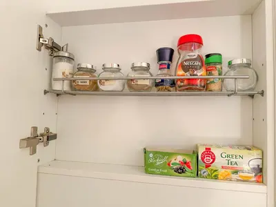 a pantry with a shelf with jars of food at Cozy Apartment by Wenceslas Square and Main Train Station in Prague