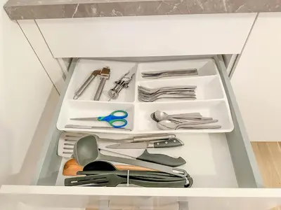 a drawer in a cabinet filled with utensils at Cozy Apartment by Wenceslas Square and Main Train Station in Prague