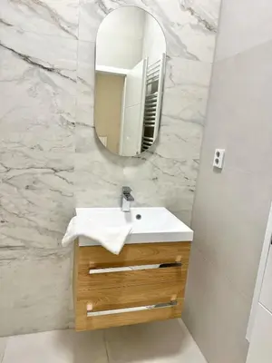 a bathroom with a sink and a mirror at Modern 2BED with st Ludmila view and entire square in Prague