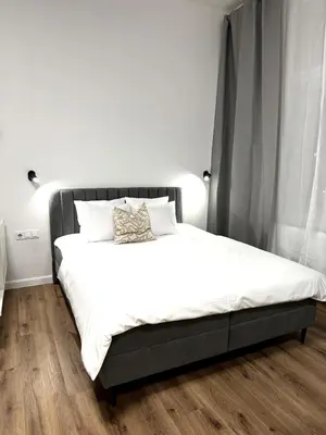 a bedroom with a large bed with white sheets at Mystical 2-bed Apartment in heart of Prague in Prague