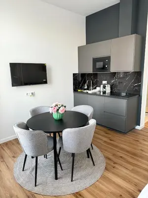 a dining room table with chairs and a kitchen at Mystical 2-bed Apartment in heart of Prague in Prague