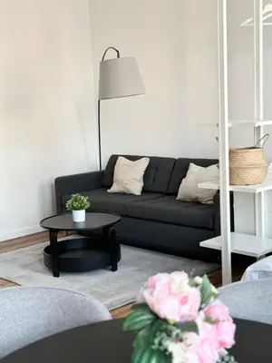 a living room with a black couch and a table at Mystical 2-bed Apartment in heart of Prague in Prague