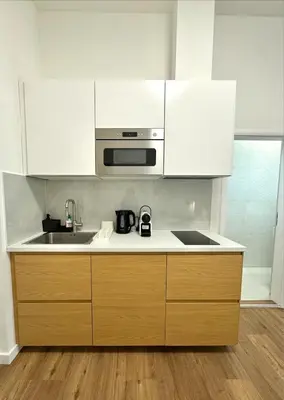 a kitchen with white cabinets and a sink at Cozy One-Room Apartment in heart of Prague in Prague