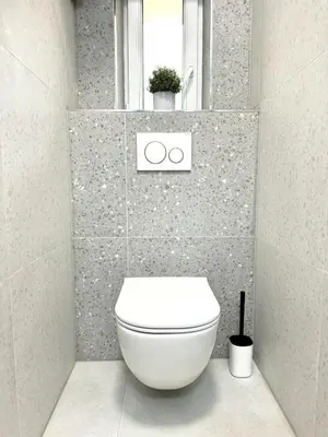 a bathroom with a white toilet and a window at Cozy One-Room Apartment in heart of Prague in Prague