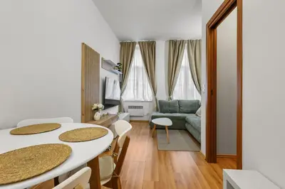 a living room with a table and chairs and a couch at Cozy stay near City Center - Žižkov in Prague