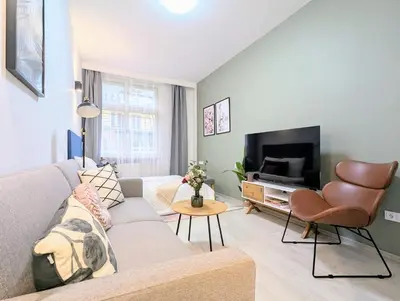 a living room with a couch and a tv at Old Town 2 BDR, free coffee in Prague