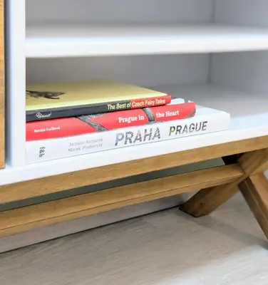 a stack of books sitting on a shelf at Old Town 2 BDR, free coffee in Prague