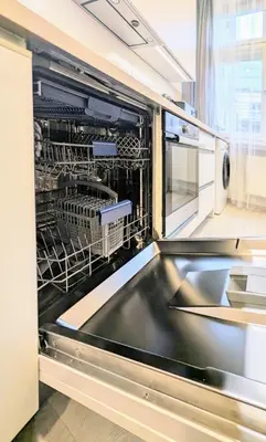a dishwasher with dishes in it in a kitchen at Old Town 2 BDR, free coffee in Prague