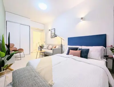 a bedroom with a large bed with a blue headboard at Old Town 2 BDR, free coffee in Prague