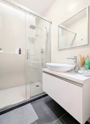 a white bathroom with a sink and a shower at Old Town 2 BDR, free coffee in Prague