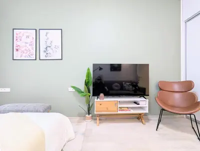 a bedroom with a bed and a chair and a tv at Old Town 2 BDR, free coffee in Prague