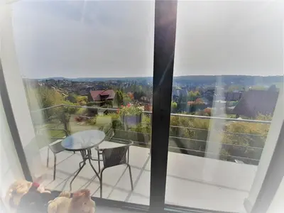 a balcony with a table and chairs in front of a window at Holiday Home in Kladno with Private Pool in Lány