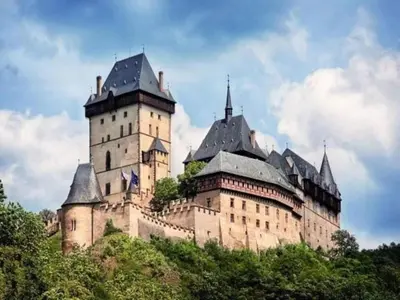 a large castle with two towers on a hill at Holiday Home in Kladno with Private Pool in Lány