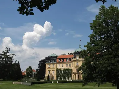 a large building with a roof on a field at Holiday Home in Kladno with Private Pool in Lány