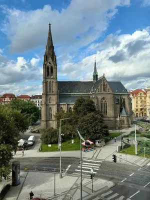 an old church with a clock tower in a city at Elegant & Classy 1BR Apartment in Central Prague in Prague
