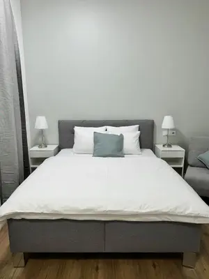 a bedroom with a large bed with two lamps at Elegant & Classy 1BR Apartment in Central Prague in Prague