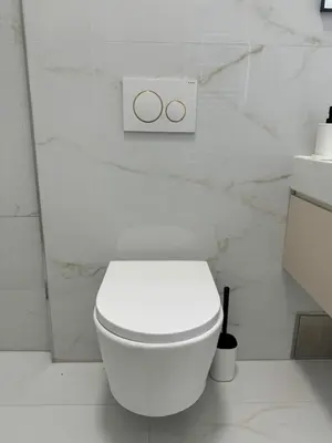 a white bathroom with a white toilet in a room at Elegant & Classy 1BR Apartment in Central Prague in Prague