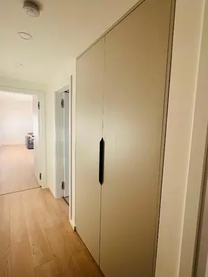a sliding door in a room with a hallway at New sunny rooftop apartment with a terrace 10 minutes from city centre in Prague