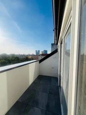 a balcony with a view of the city at New sunny rooftop apartment with a terrace 10 minutes from city centre in Prague