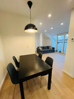 a black dining room table with chairs and a couch at New sunny rooftop apartment with a terrace 10 minutes from city centre in Prague