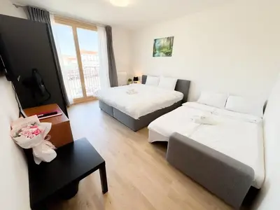 a hotel room with two beds and a couch at Nest Home Prague center in Prague