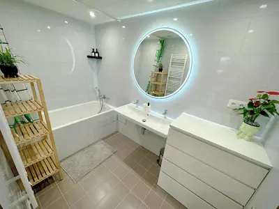 a bathroom with a tub and a sink and a mirror at Nest Home Prague center in Prague