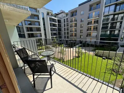 a balcony with a table and chairs and some buildings at Nest Home Prague center in Prague