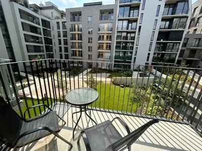 a balcony with a table and chairs and some buildings at Nest Home Prague center in Prague