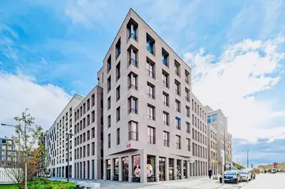 a tall white building on a city street at Nest Home Prague center in Prague