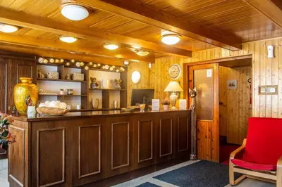 a lobby with a bar and a red chair at Hotel Konopiště Nová Myslivna in Benešov