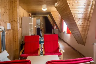 a room with two red chairs and a table at Hotel Konopiště Nová Myslivna in Benešov