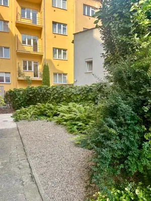 a green hedge in front of a building at Byt Podoli in Prague