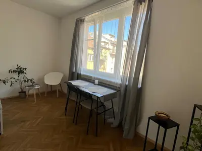 a dining room with a table and a window at Byt Podoli in Prague
