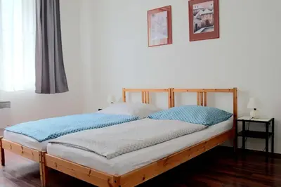 a bedroom with a wooden bed with blue pillows at Jezerka Apartments - Free Parking - Easy Access to Center in Prague