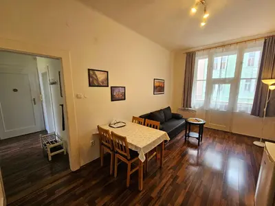 a living room with a table and a couch at Jezerka Apartments - Free Parking - Easy Access to Center in Prague