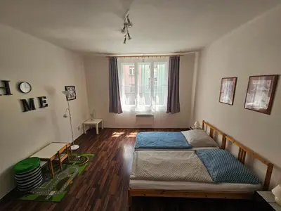 a bedroom with a bed in the middle of a room at Jezerka Apartments - Free Parking - Easy Access to Center in Prague