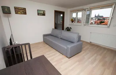 a living room with a couch and a table at Greg Apartments Kampa Prague in Prague