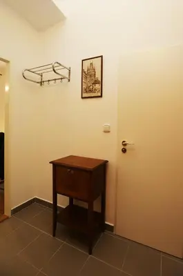 a room with a door and a table and a shelf at Greg Apartments Kampa Prague in Prague