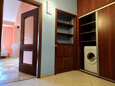 a laundry room with a door and a washer and dryer at Spacious two-room apartment in Prague in Prague