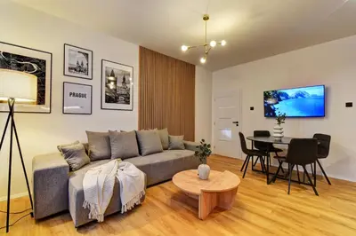 a living room with a couch and a table at Long Street Deluxe Suite Apartment Prague in Prague