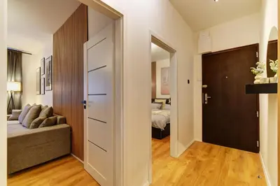 a living room with a couch and a bedroom at Long Street Deluxe Suite Apartment Prague in Prague