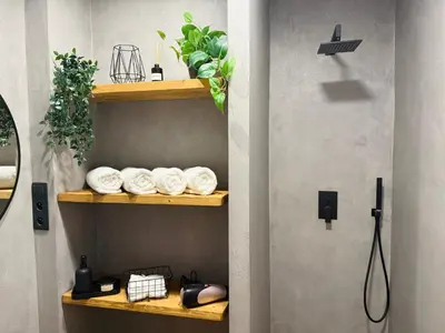 a bathroom with wooden shelves with towels at Long Street Deluxe Suite Apartment Prague in Prague
