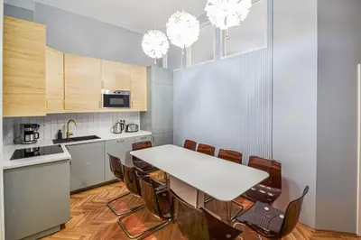 a kitchen with a white table and chairs at Celebration Flat by Ruterra in Prague