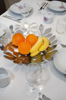 a plate of oranges and bananas on a table at Celebration Flat by Ruterra in Prague
