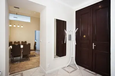 a room with a door and a dining room at Celebration Flat by Ruterra in Prague